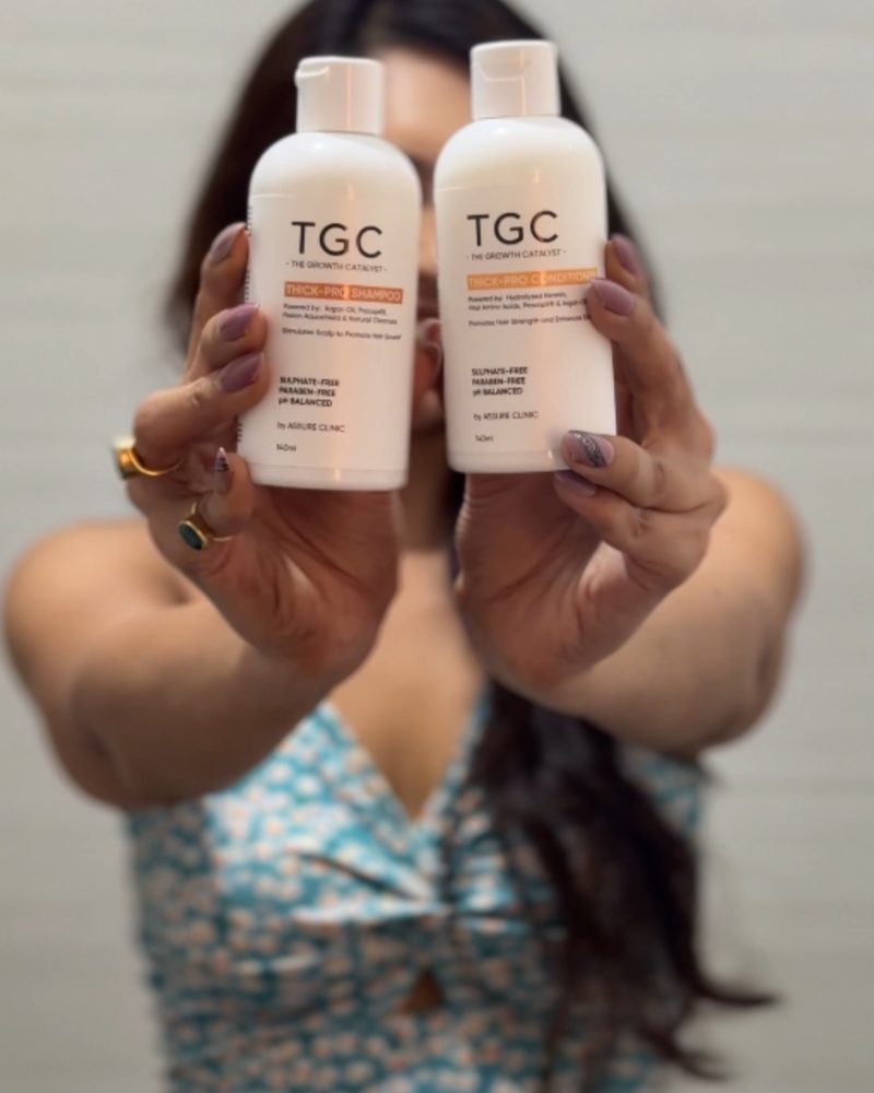 Nibedita holding the Thick-Pro shampoo and conditioner